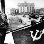 Soviet soldiers hosting the Soviet flag on the balcony of Hotel Adlon in Berlin after the fall of the city. Bundesarchiv, Bild 183-R77767 / CC-BY-SA
